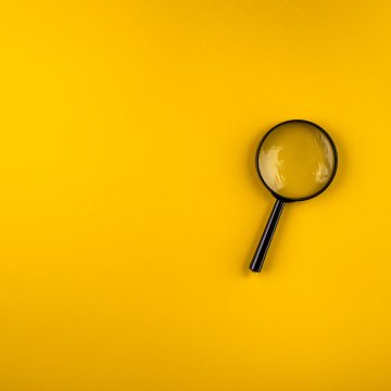 best background check services 2019 magnifying glass on yellow background
